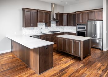A kitchen with wooden cabinets and stainless steel appliances
